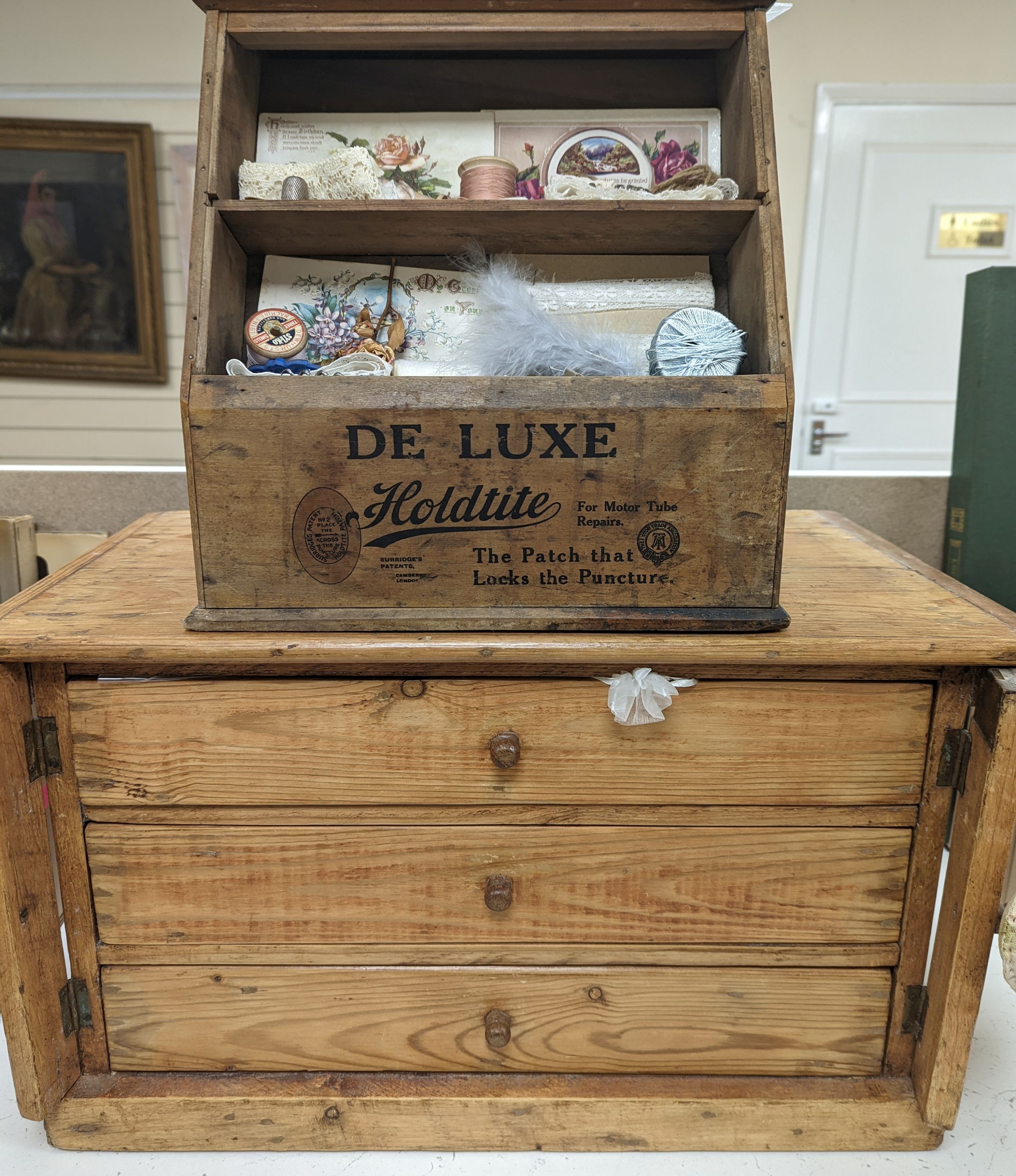 A 'Holdtite' shop cabinet and a pine three drawer chest, housing some costume jewellery